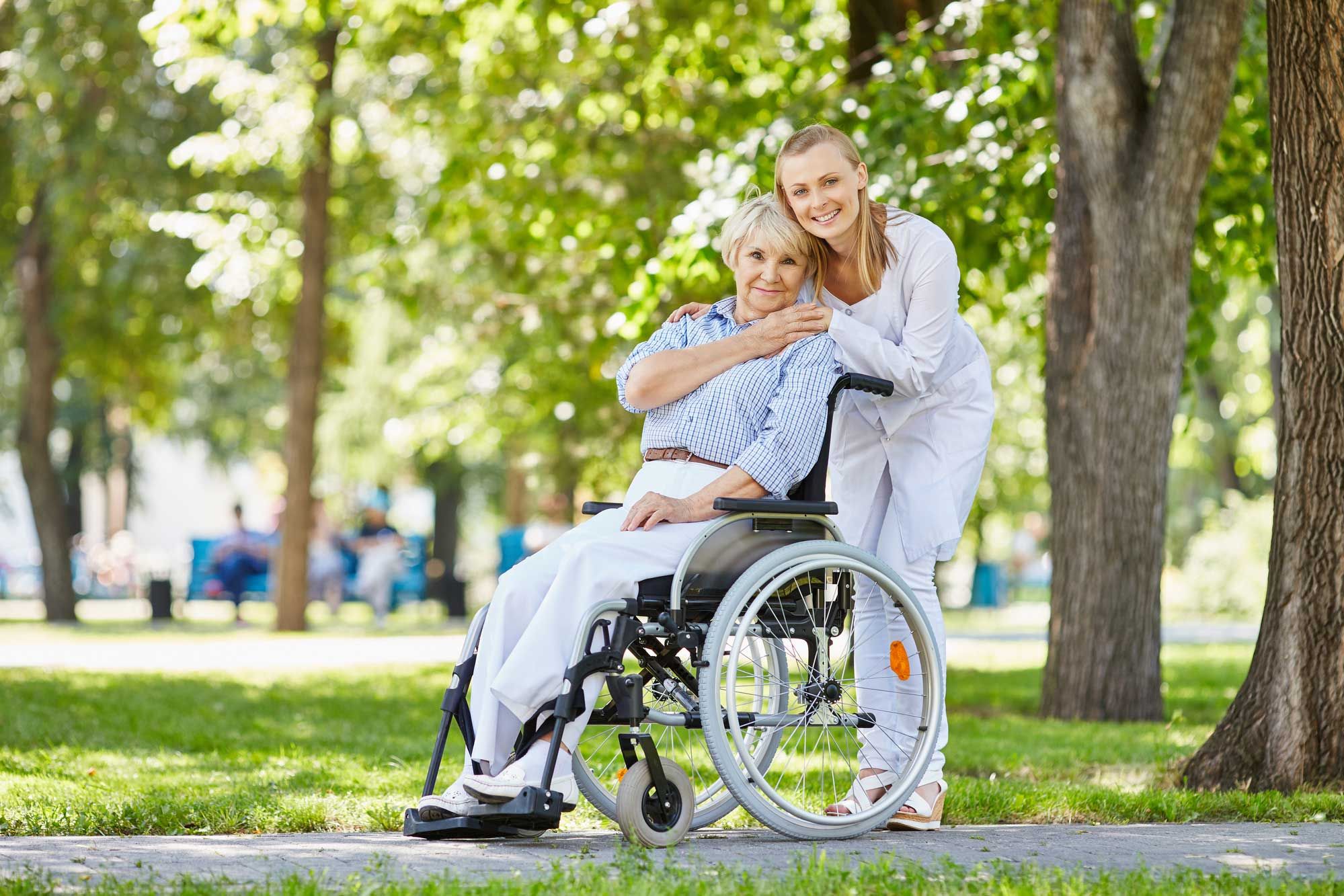 Elder care professional wiith senior in wheelchair